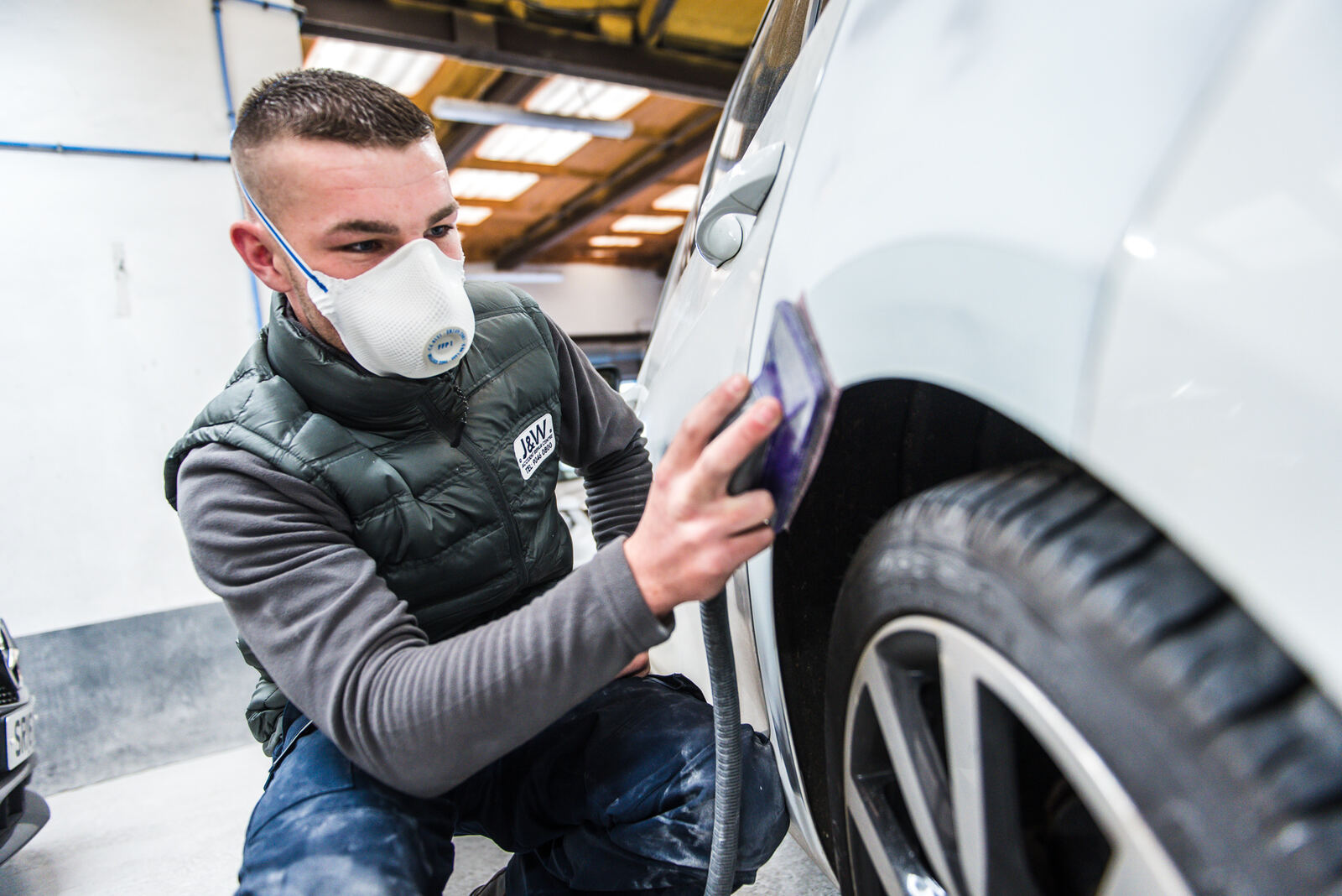 J&W technician preparing a car panel in the workshop