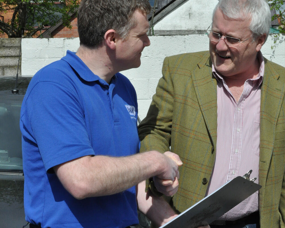 A J&W team member shaking hands with a customer
