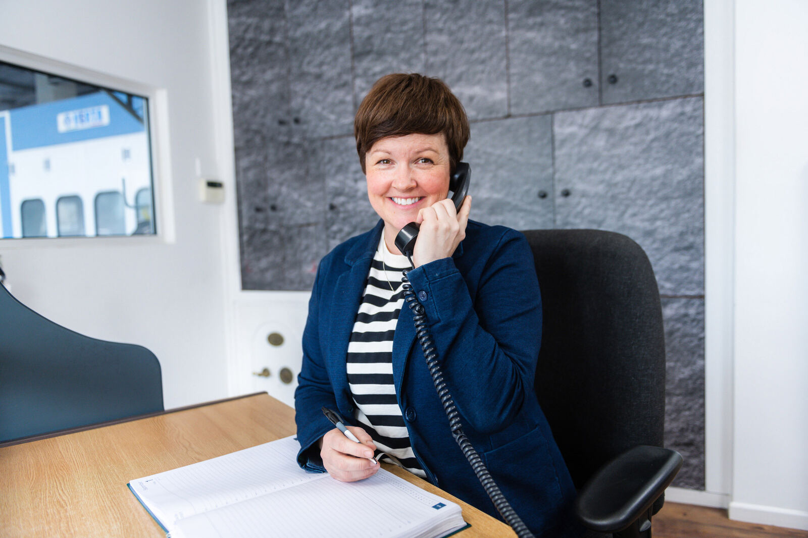 A member of the J&W office team on the phone at her desk