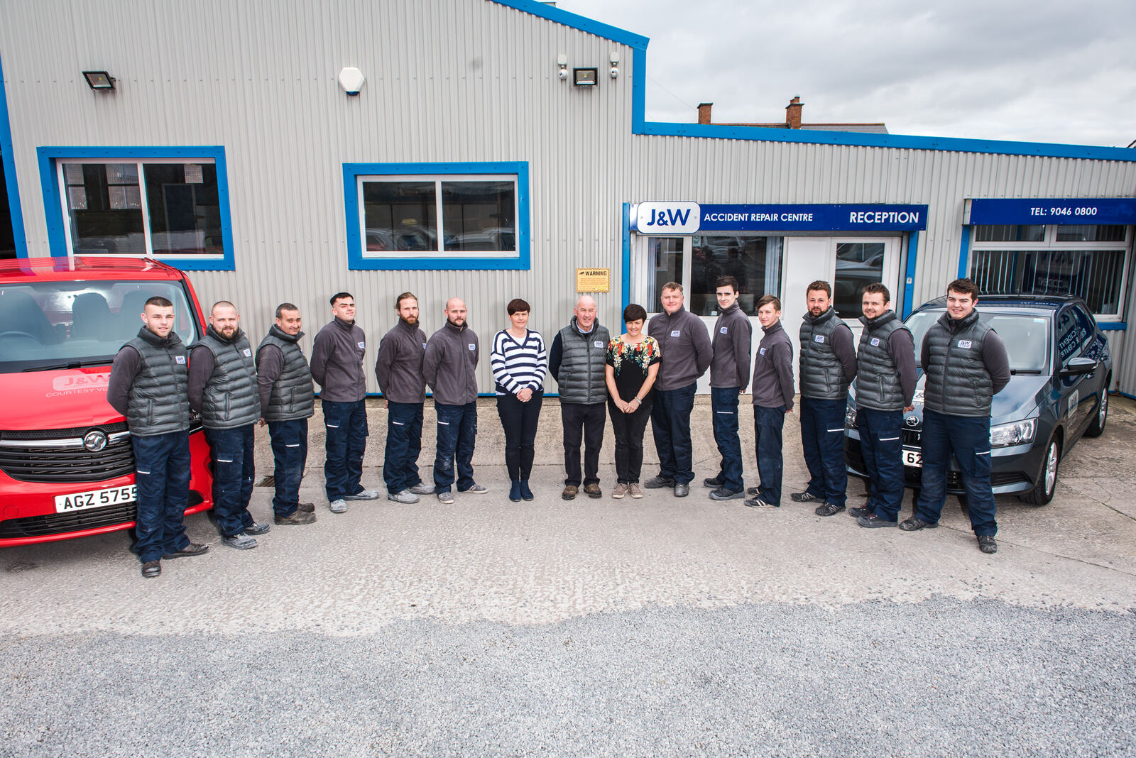 The J&W team lined up outside the repair centre with courtesy vehicles