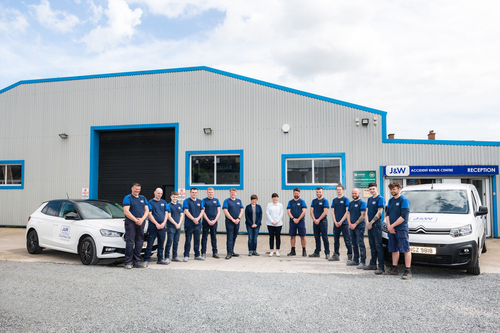 The J&W Body Repairs team in uniform outside their accident repair centre in Loopland Park, Belfast